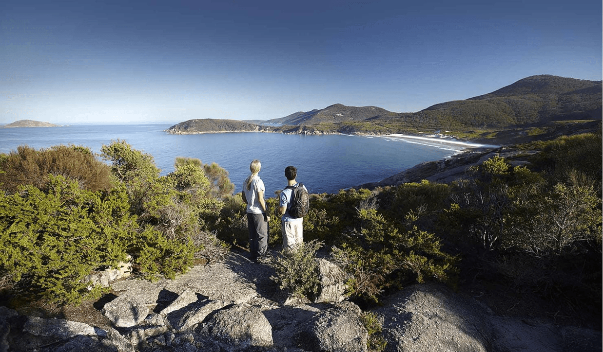 Two people are overlooking the scenery at Wilsons Prom.