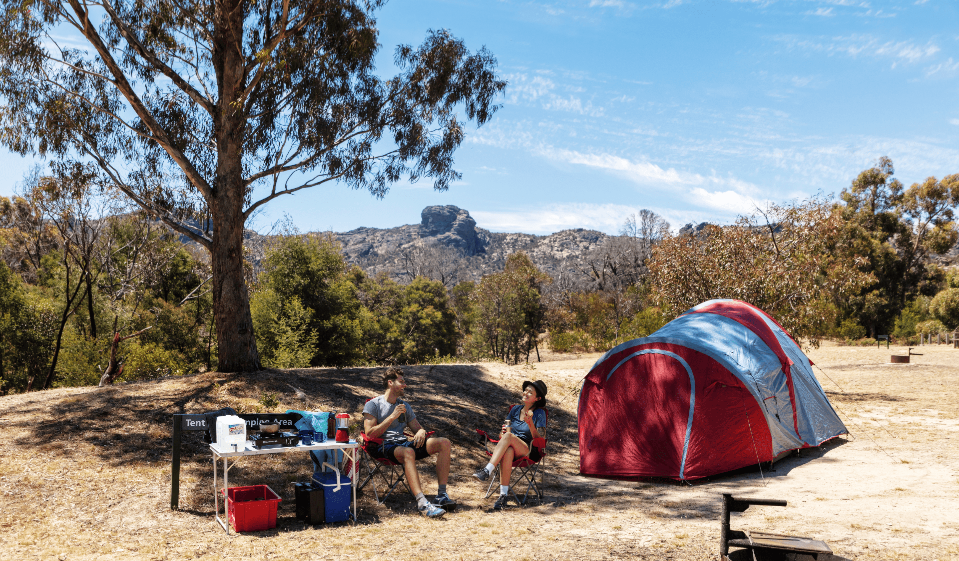 Friends relaxing in front of their campsite at Stapylton Campground, Grampians National Park
