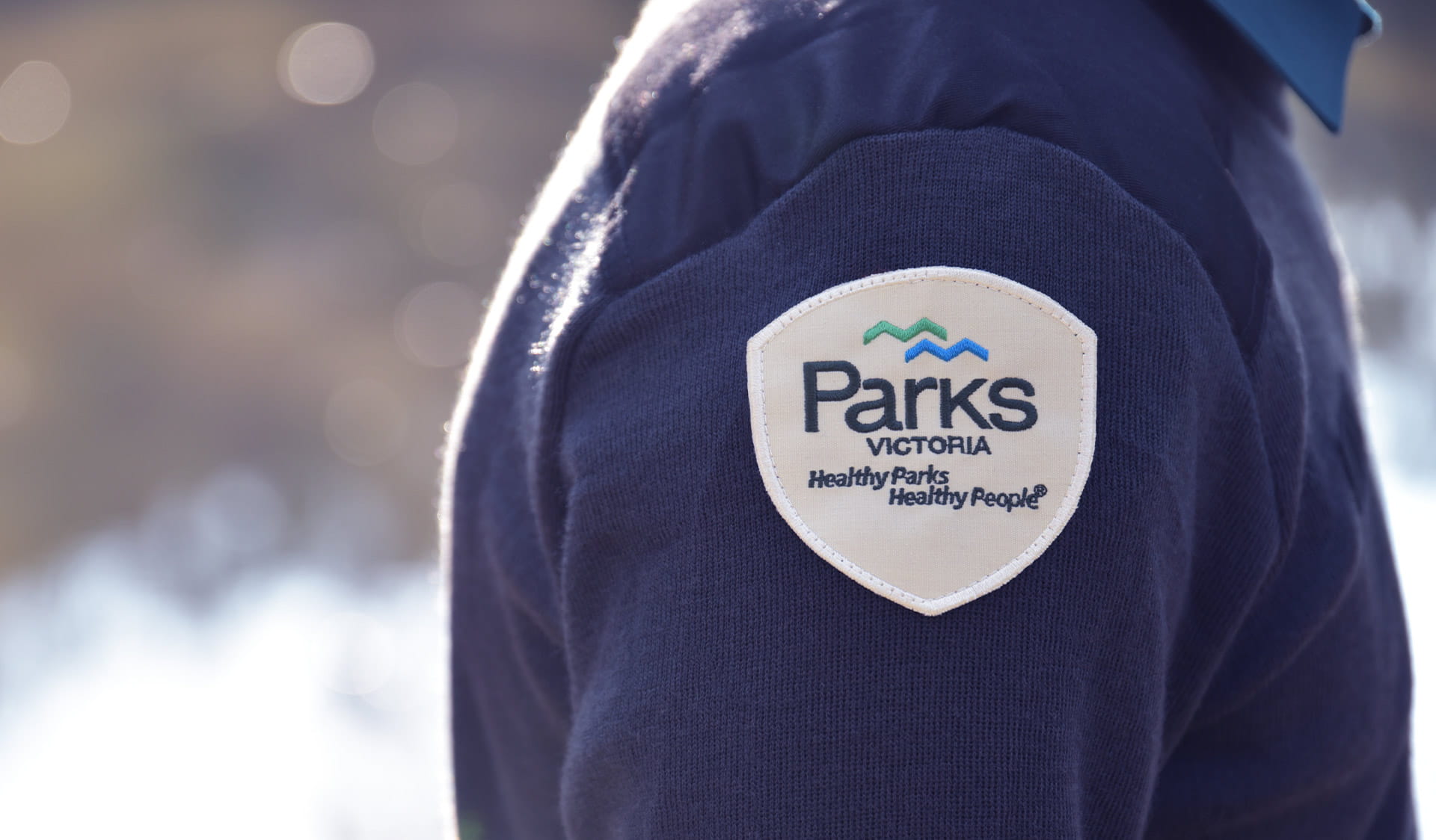 Close up photo of the Parks Victoria - Healthy Parks, Healthy People badge on a ranger uniform