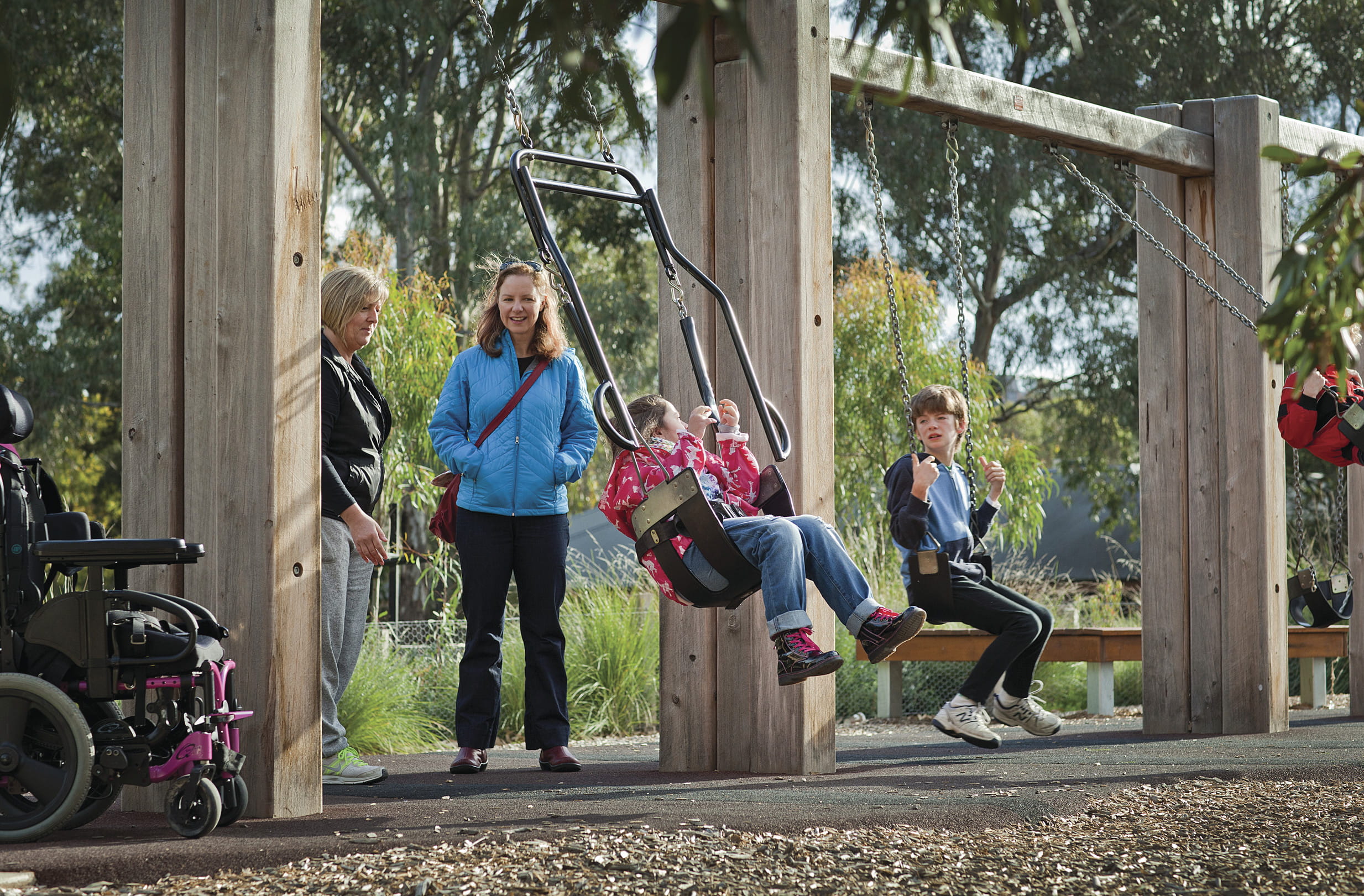 Child on swing with adult behind