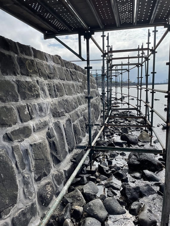 Like-for-like grout repairs are being made to the bluestone seawall at Point Gellibrand Coastal Heritage Park. Scaffolding is in place.