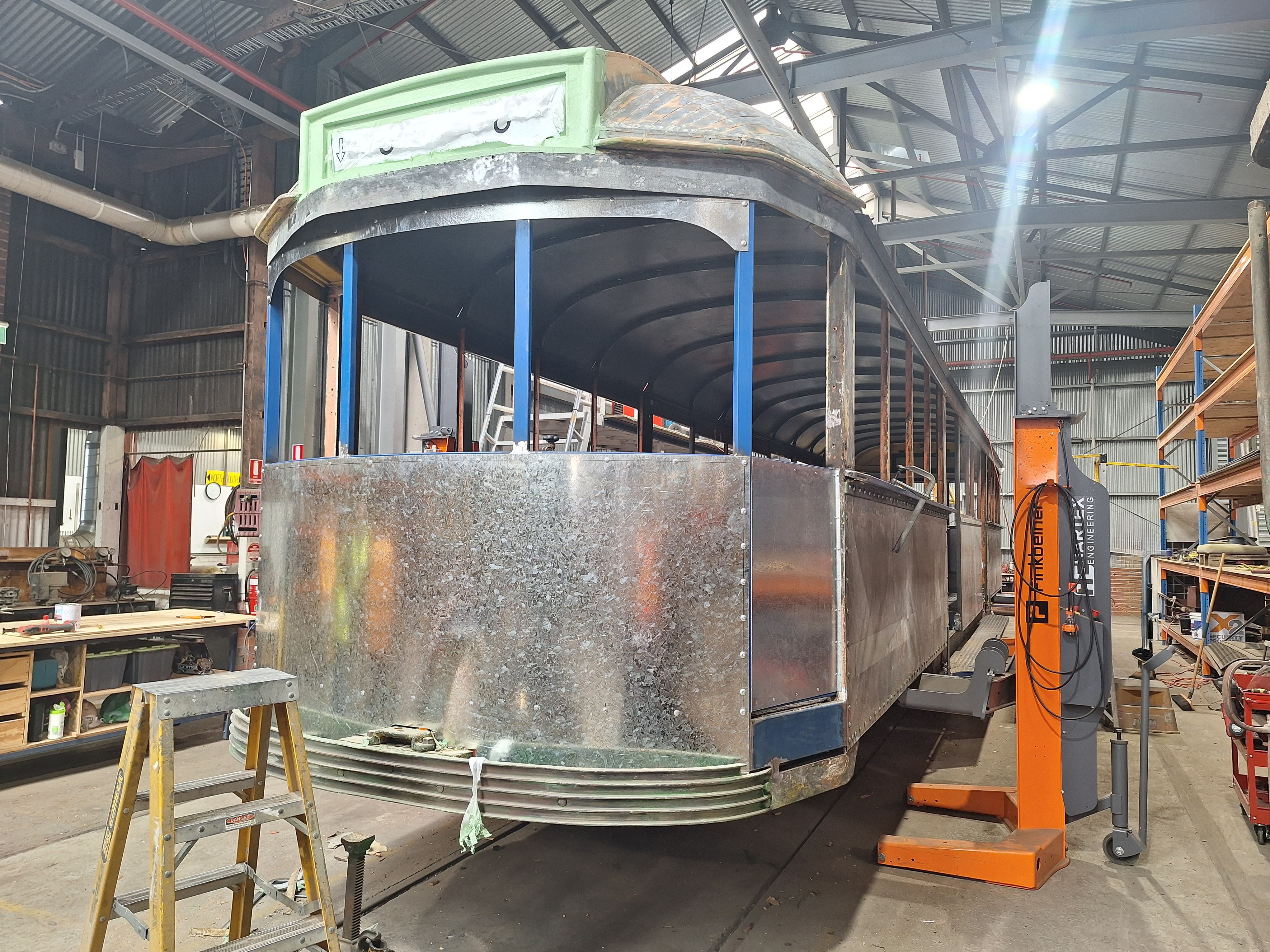 Tram in a workshop with paint stripped off
