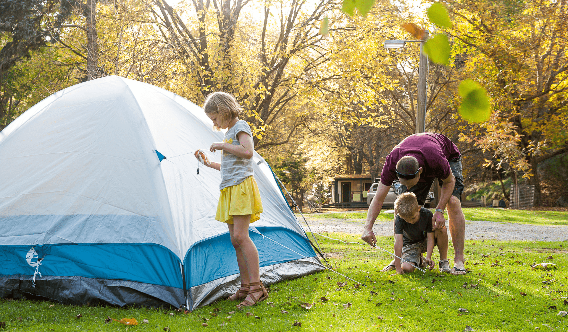 Parent helping children set up a sent at Buchan Caves Reserve Campground in Buchan Caves Reserve