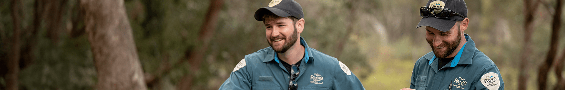 Two rangers standing next to each other outdoors