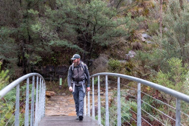 Ranger at work walking along boardwalk