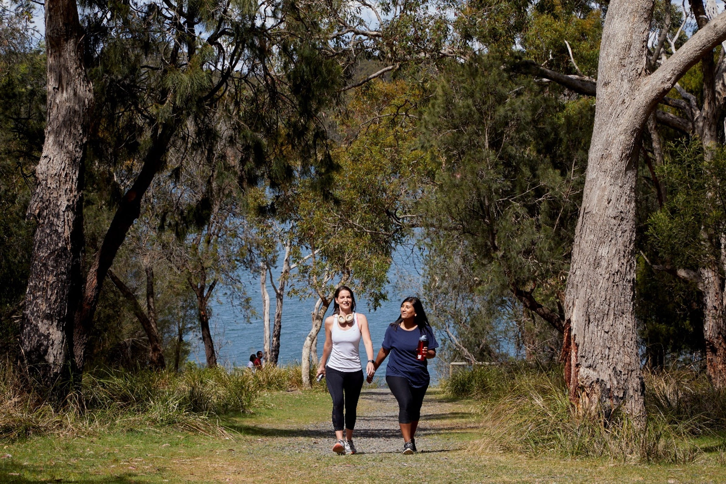 two people walking in a woody area