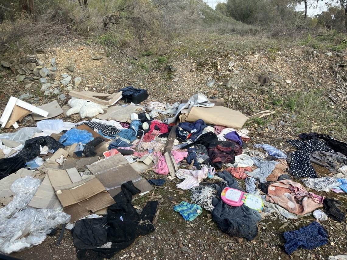 A pile of rubbish including clothes and packages