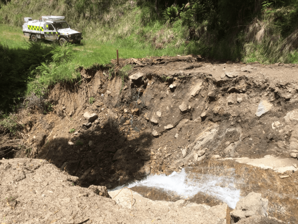 An unpaved road washed out by a landslide