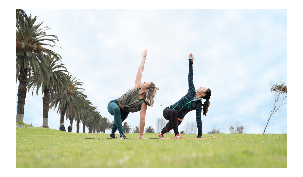 Two woman doing yoga in Albert Park