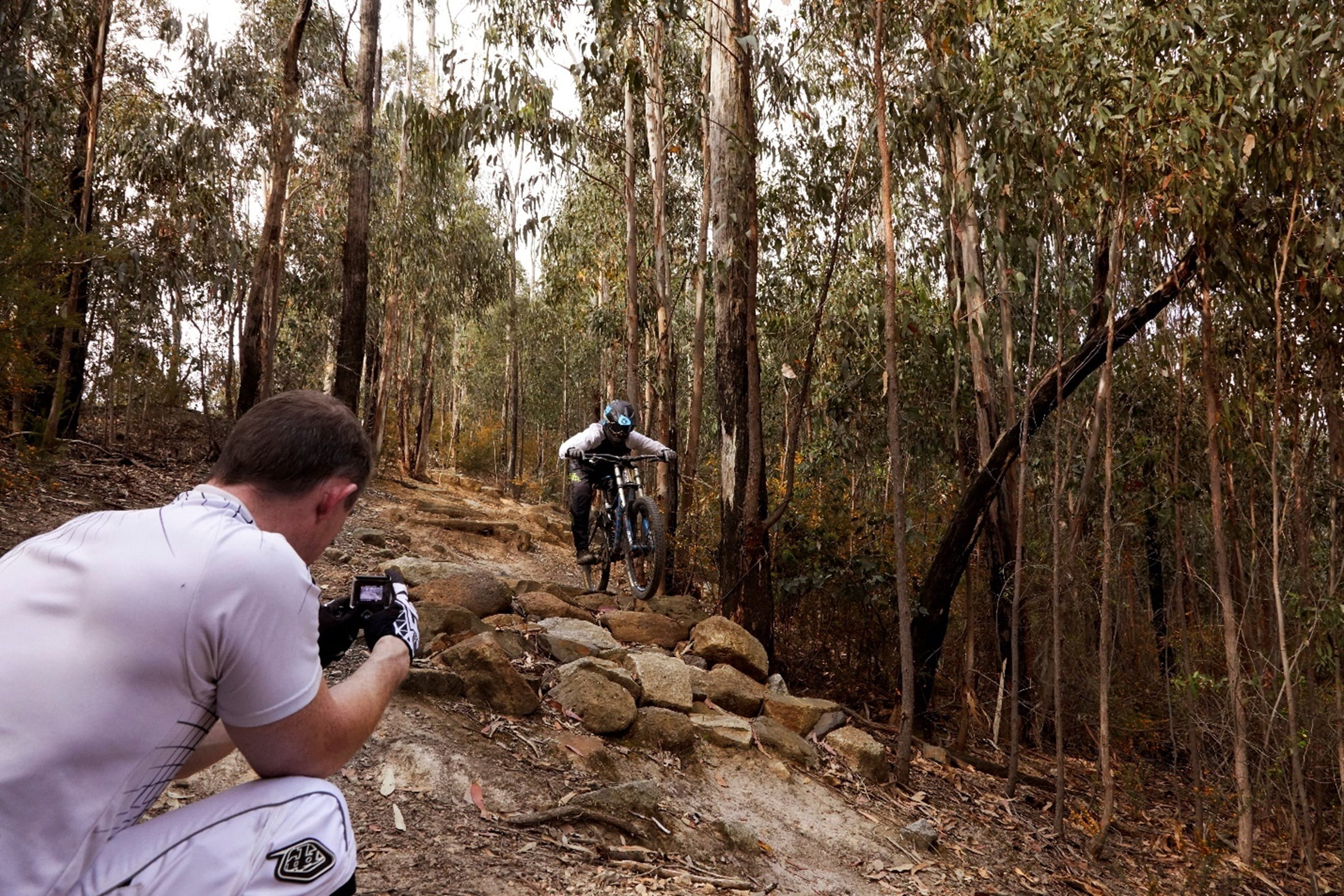 A person is filming a person on a bike