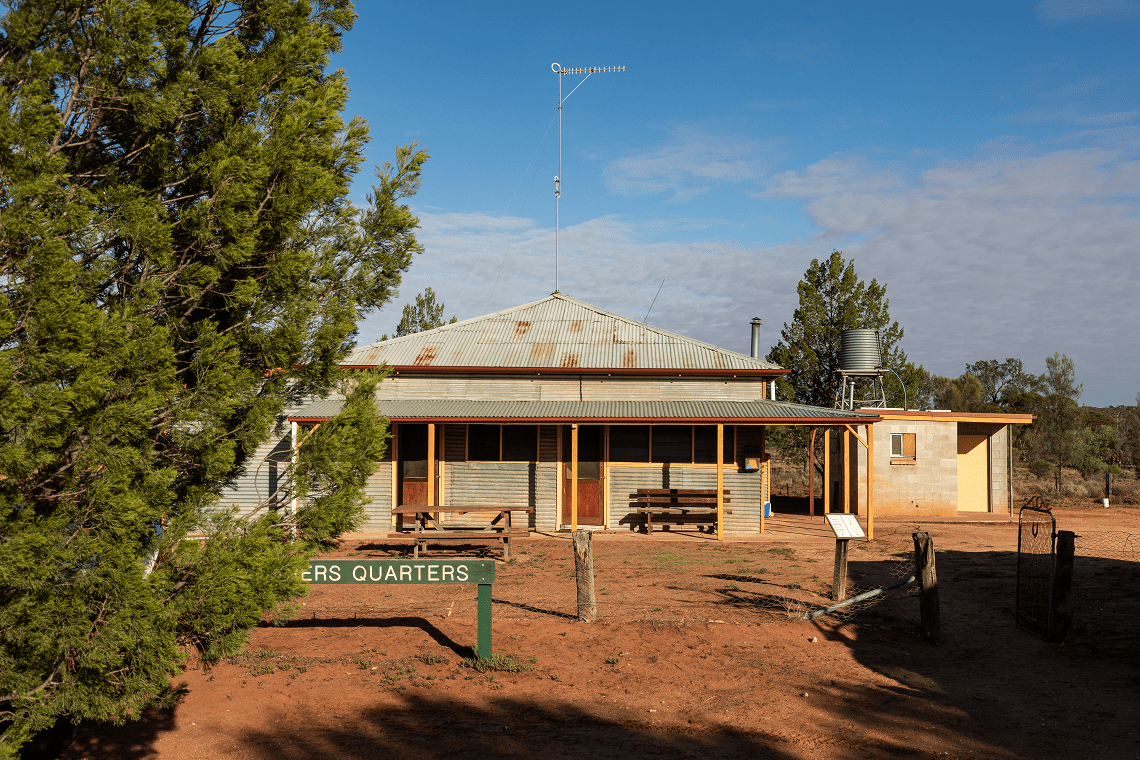 Shearers Quarters, accommodation in Murray Sunset National Park, with red dirt and a sign out the front of the building