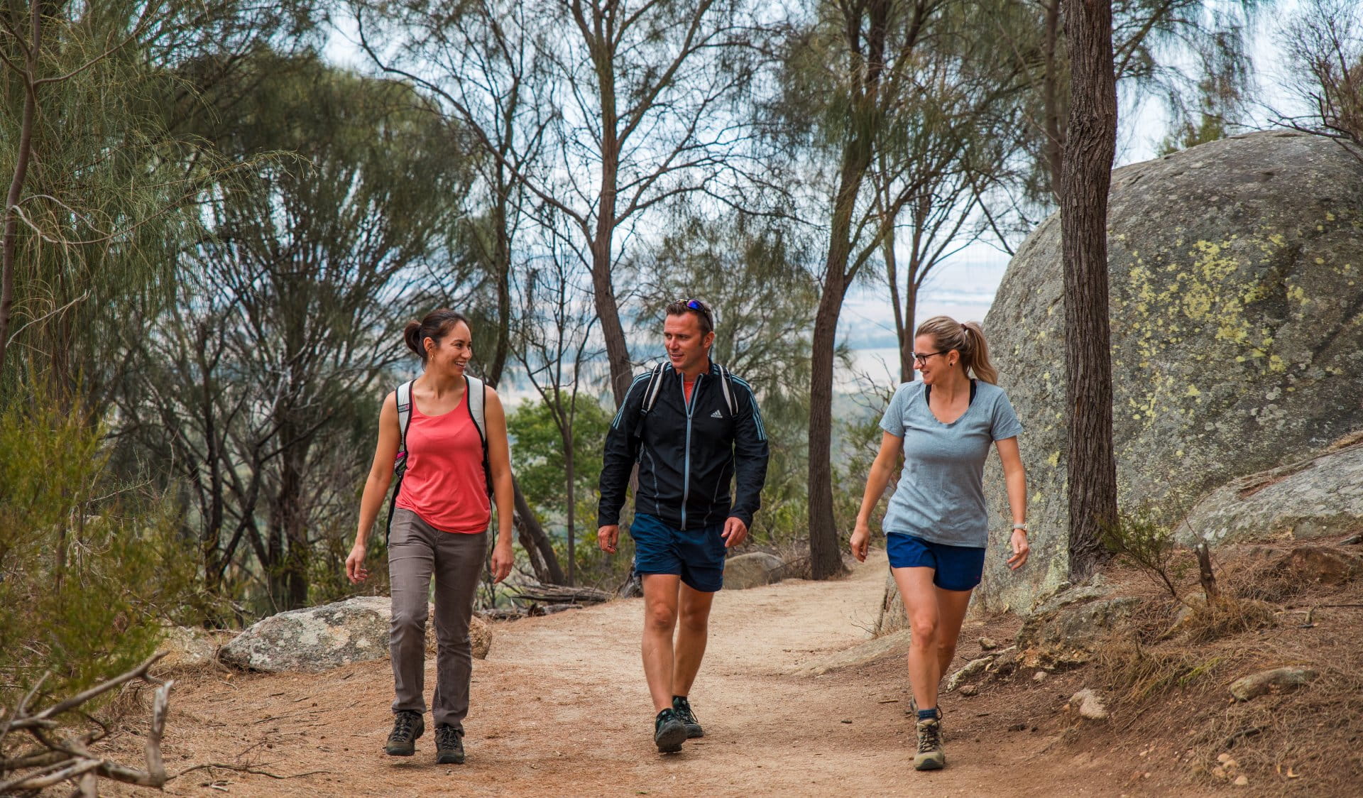 Three hikers walking on a trail in a national park. 