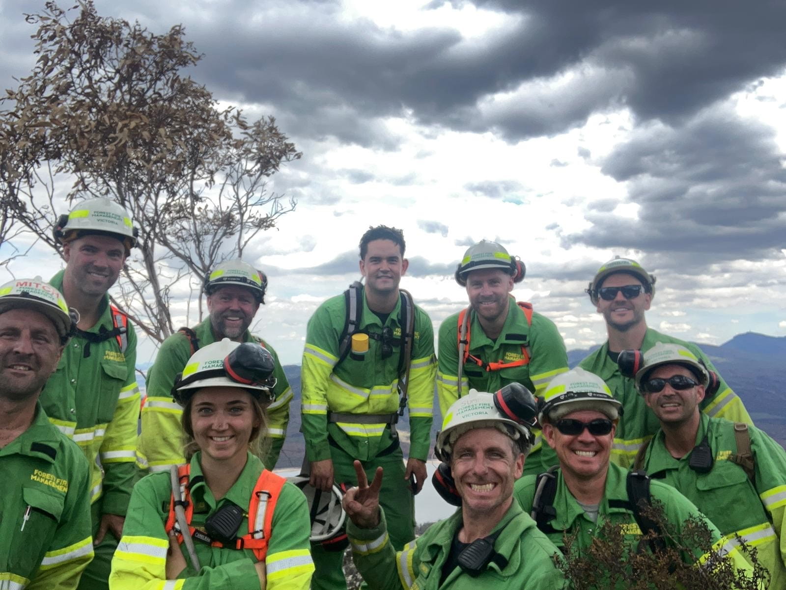 A group of Parks Victoria staff members in high vis gear, having just helped to control the Grampians fires. 