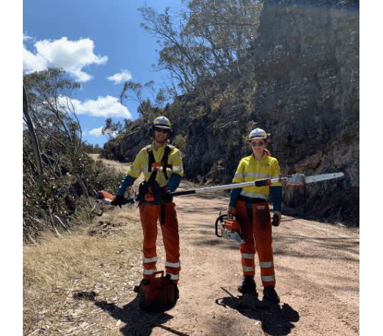 Two Parks Victoria employees standing in Alpine National Park