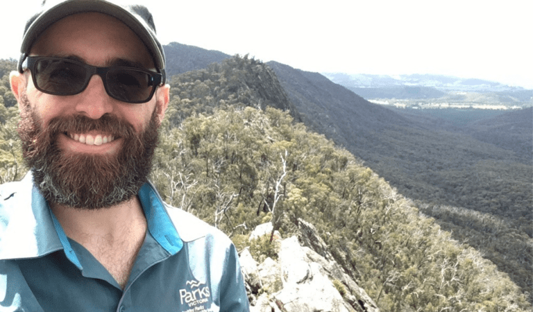Ranger standing in front of the Cathedral Ranges