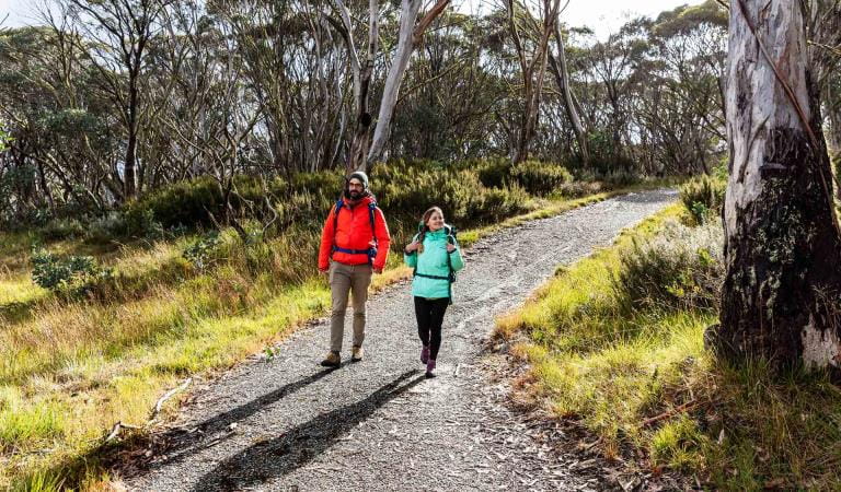 Two friends walk along the Brabralung Trail near Dinner Plain in the Alpine National Park.