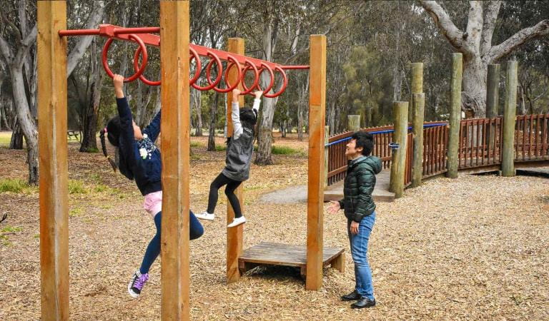 A family plays on the adventure playground at Braeside Park.