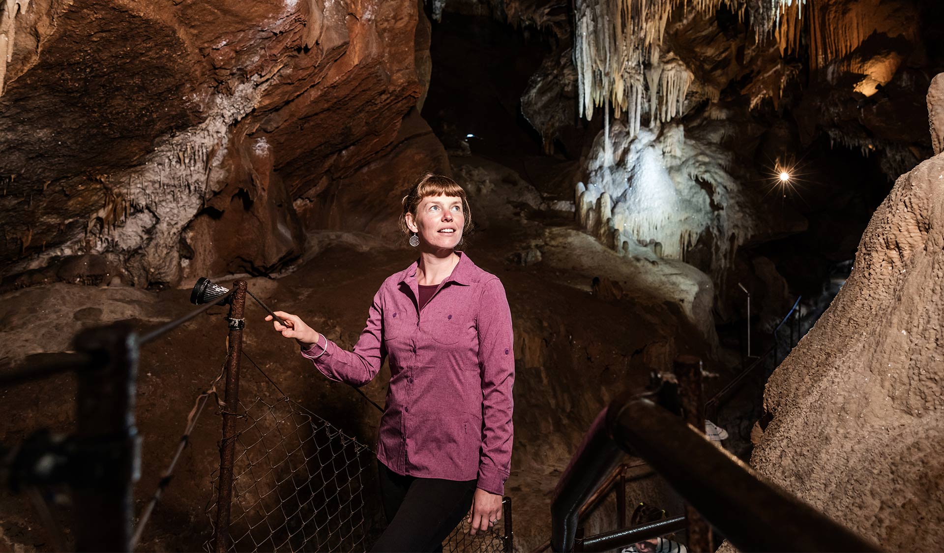 Woman exploring Fairy cave, Buchan Caves Reserve