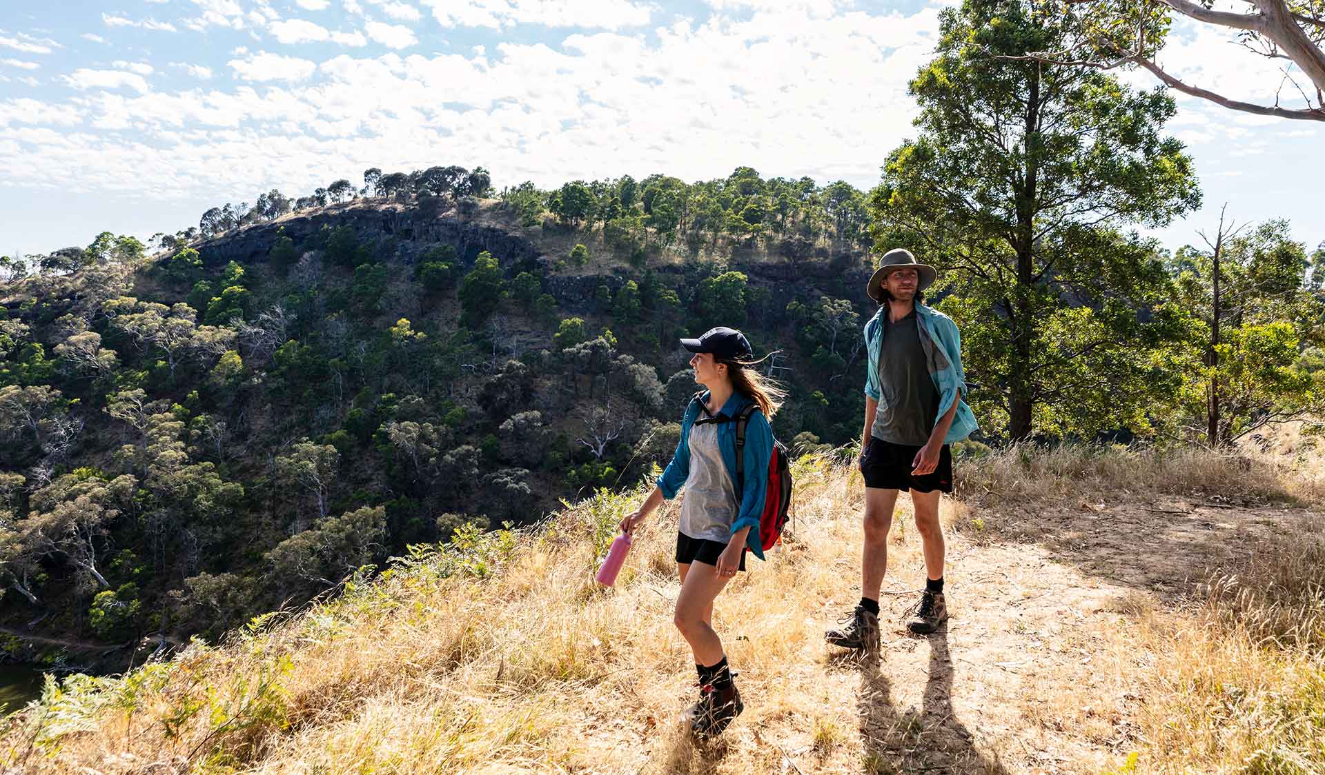 A young woman leading a man on a walk while admiring the scenery