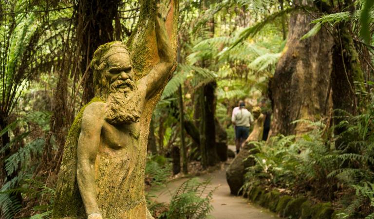 A sculpture looks over a walking path in the William Ricketts Sanctuary.