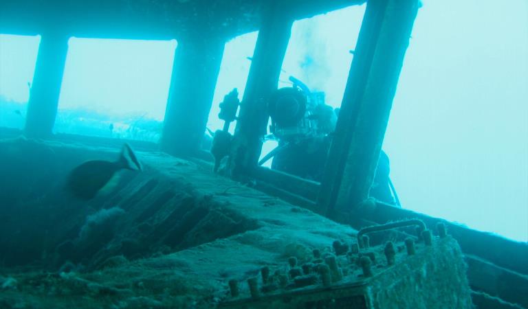 A diver takes a photo of the bridge of the Ex-HMAS Canberra