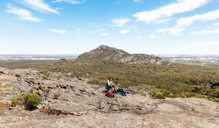 Two people stop for a picnic in front of Mount Zero in the Northern Grampians.
