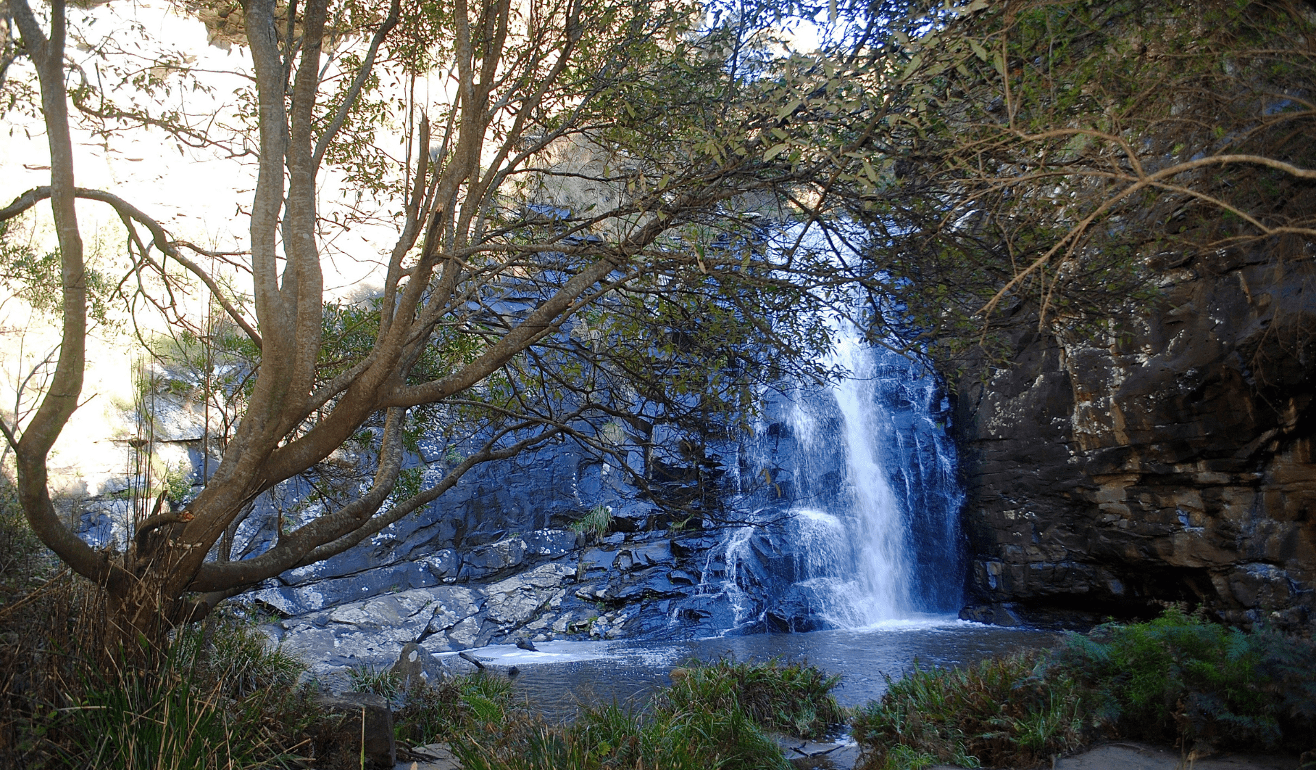 Waterfall flowing into river.