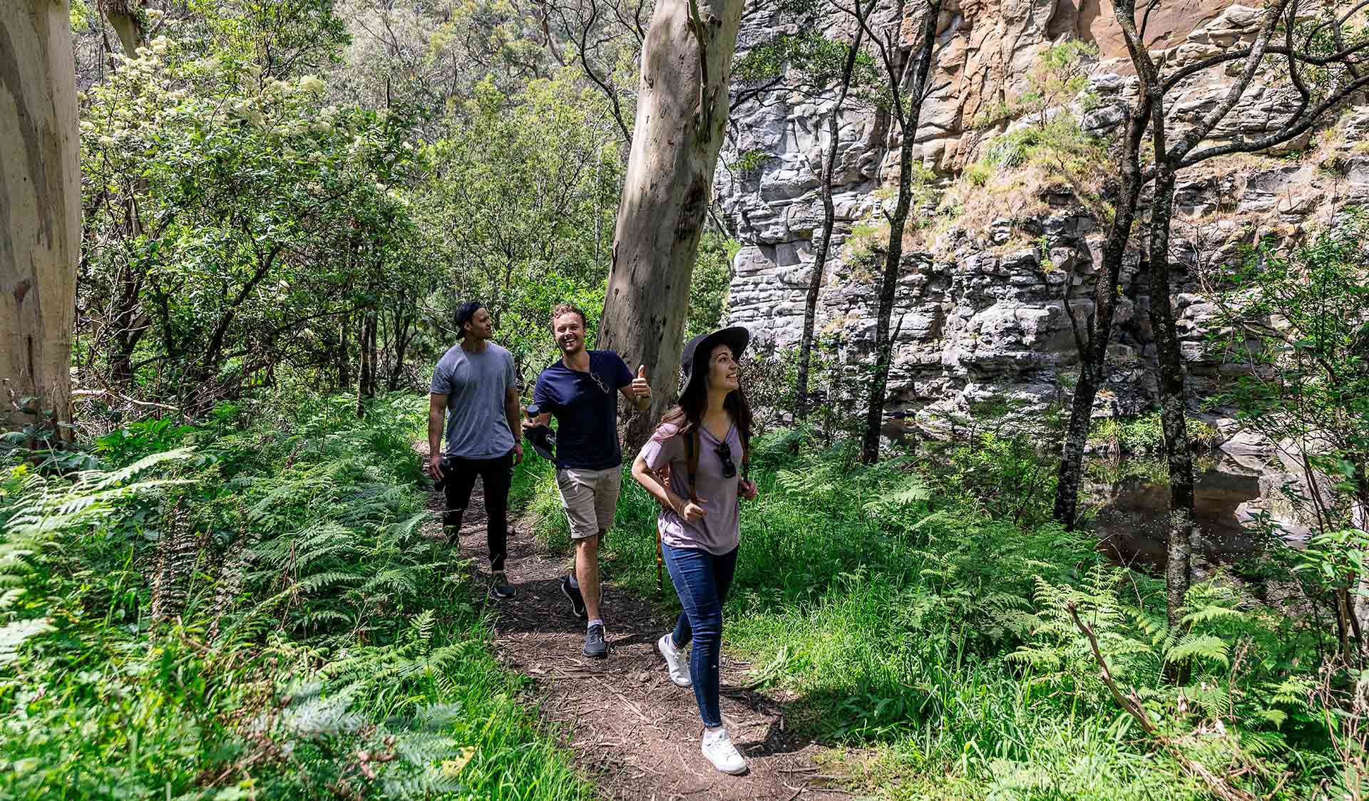 Three friends follow the track alongside the Cumberland River near Lorne in the Great Otway National Park. 