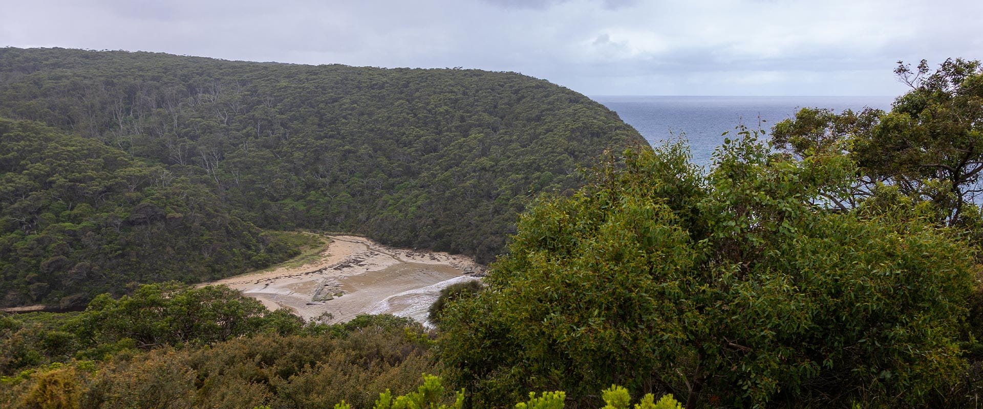 A view down towards a secluded beach.