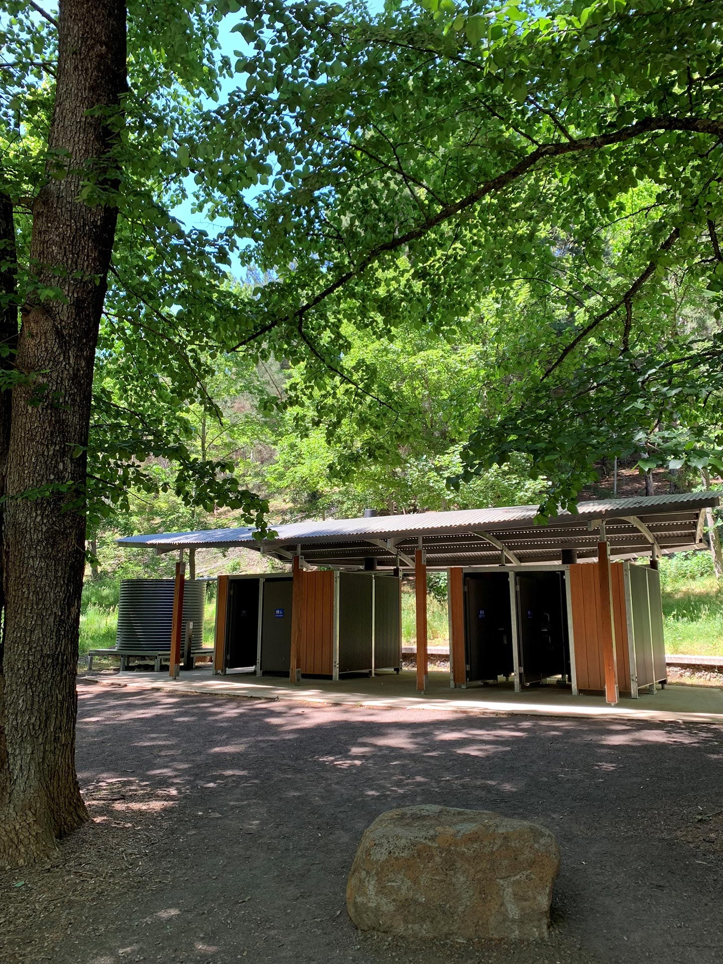 Toilet facilities surrounded by trees.
