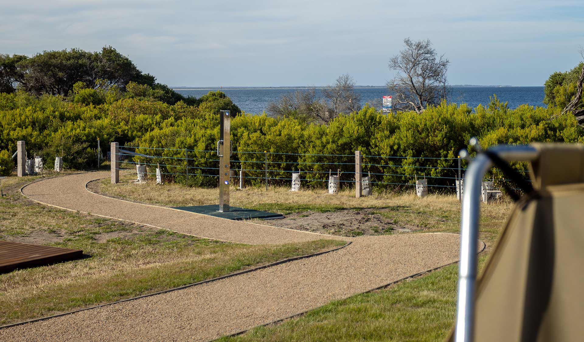 Outdoor shower in a coastal landscape.