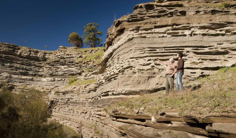 Two men discuss the formation of the crater at Tower Hill.