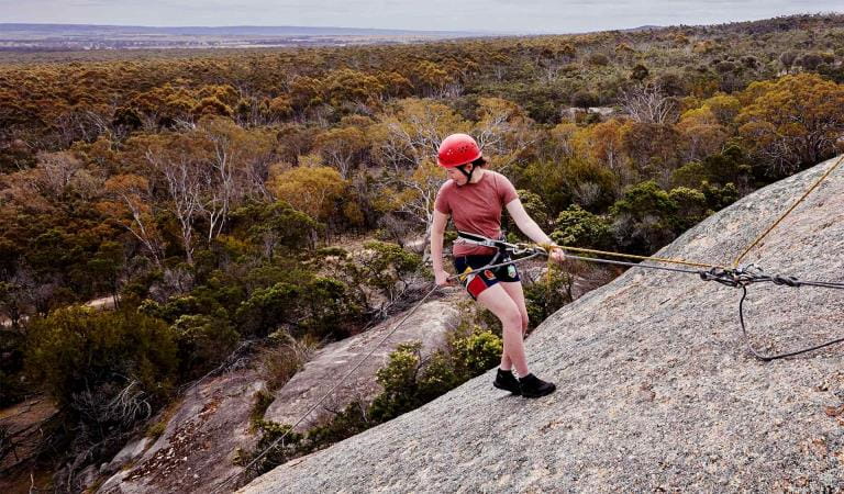 A young girl abseiling at Big Rock in You Yangs Regional Park