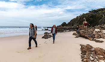 A family walking along the beach at Croajingolong National Park