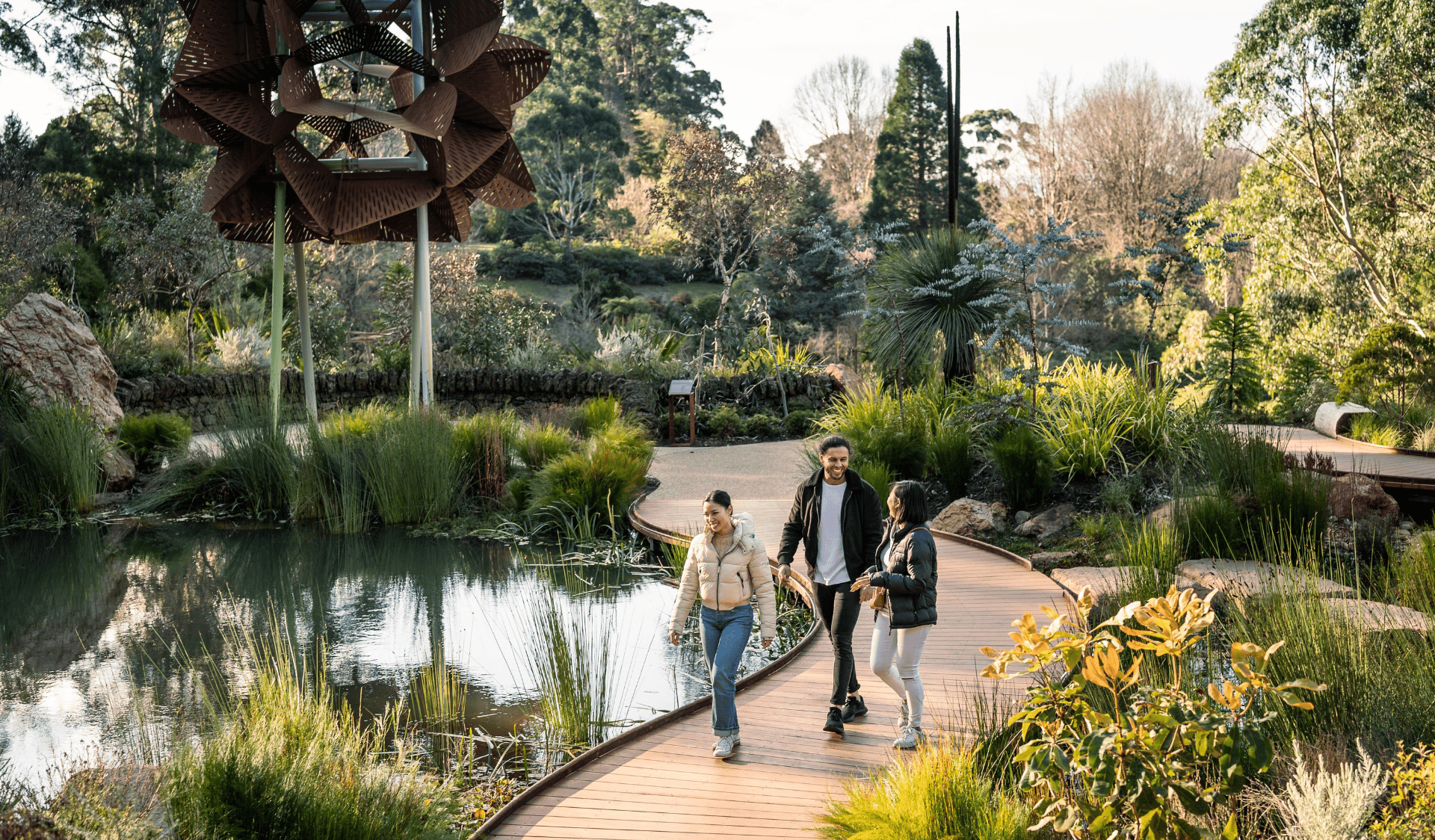 Family walks along footpath in the Dandenong Ranges Botanic Gardens