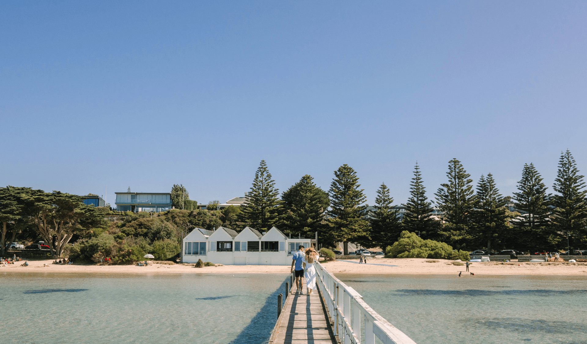 Couple walking along Sorrento Pier on a sunny day