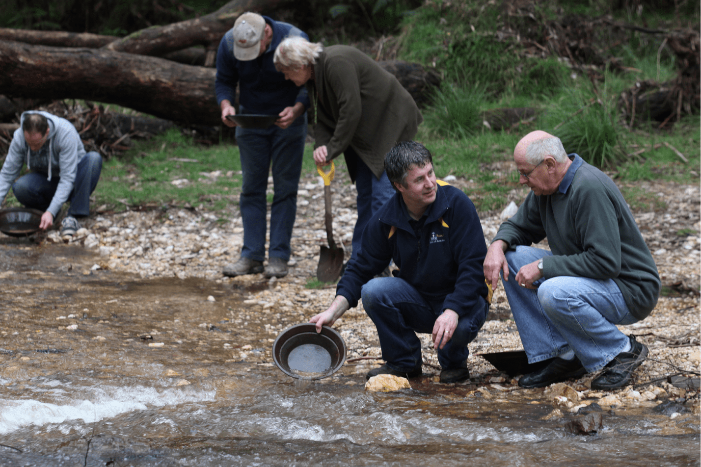 A tour group learns to pan for gold