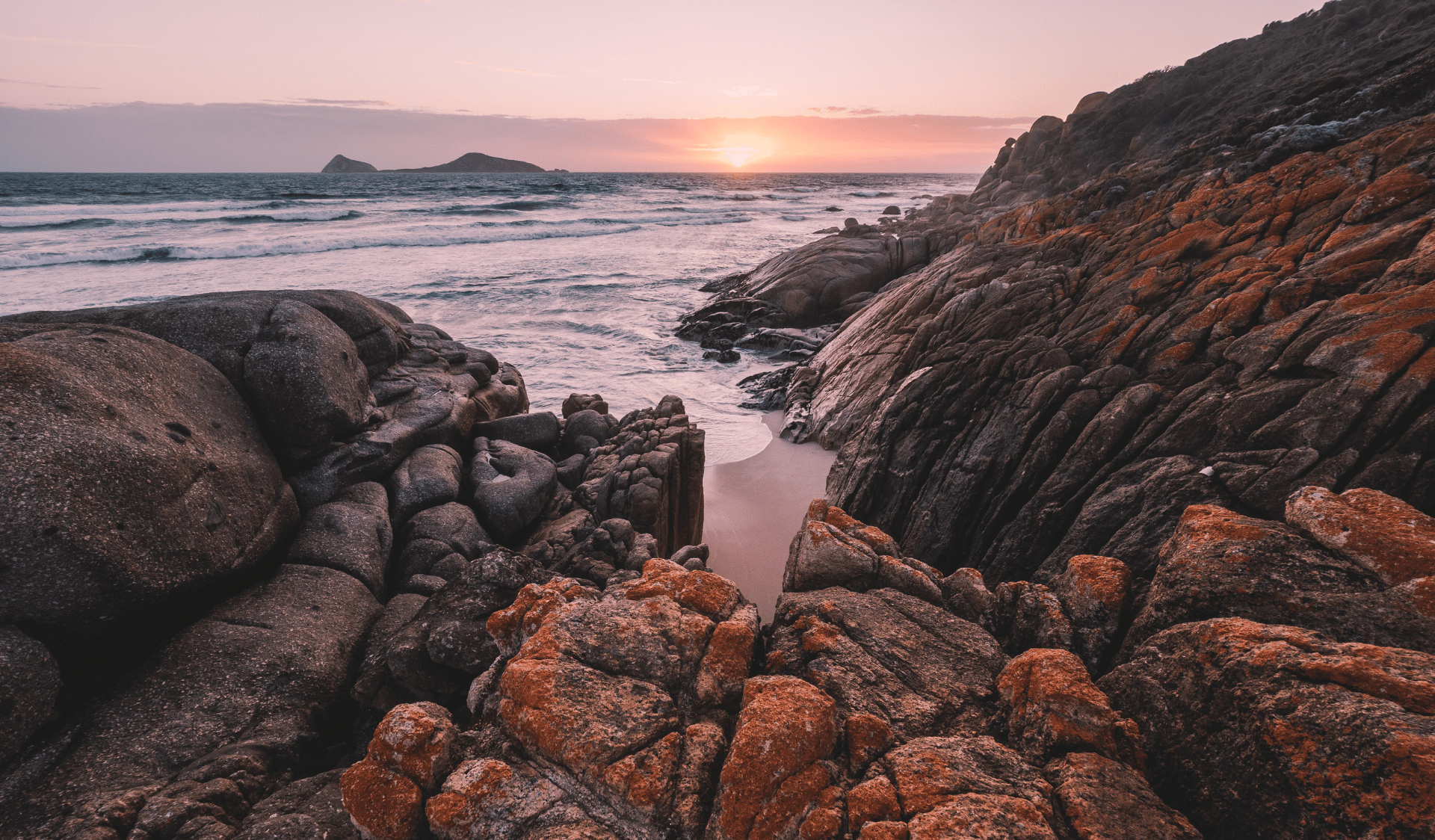 Whisky Bay has stunning sunrises over its rocky coast at Wilsons Promontory National Park, like this pink and orange coloured evening.