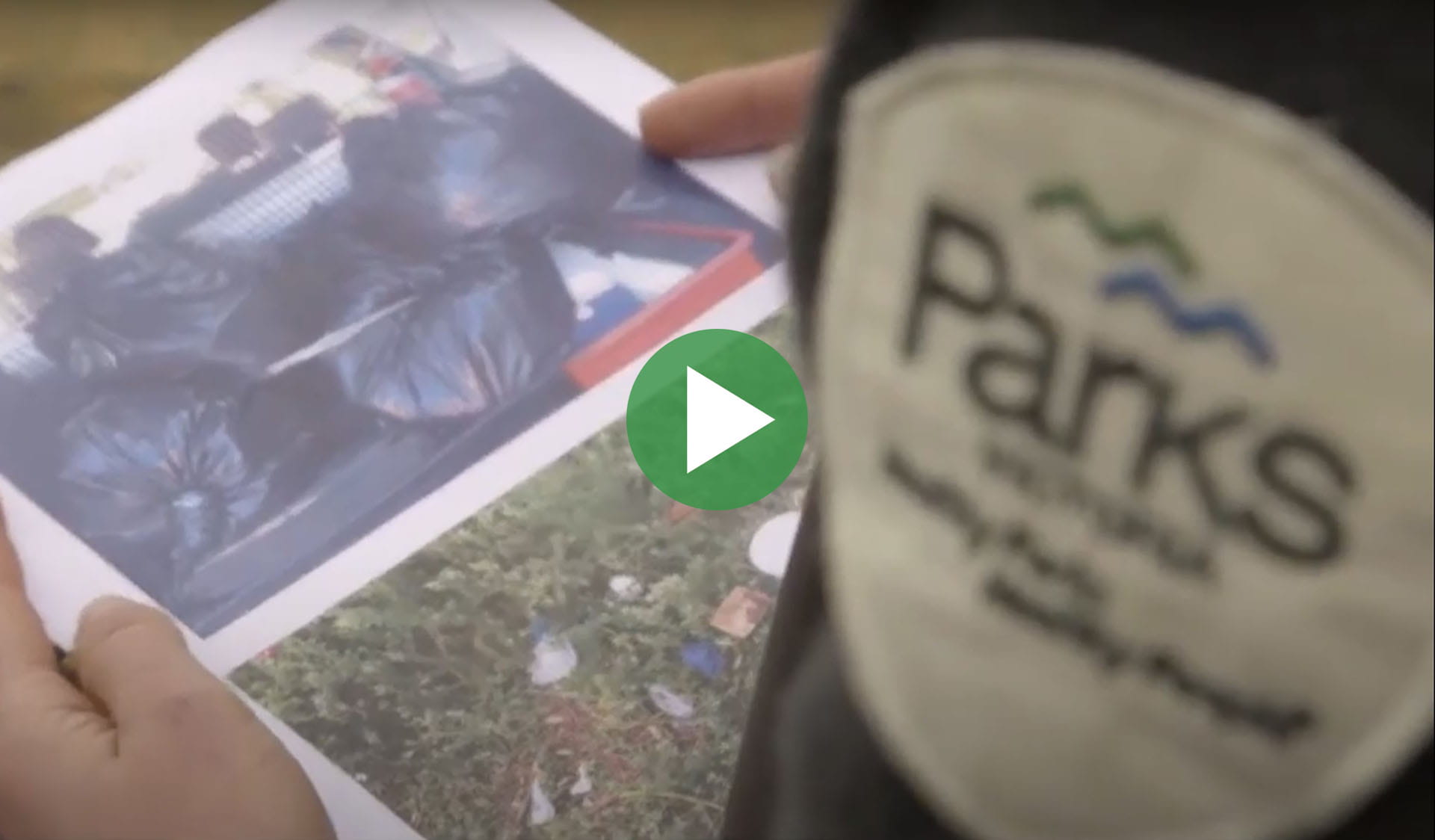 Image still from Bigger Than You - take your rubbish with you video, with play icon overlay.