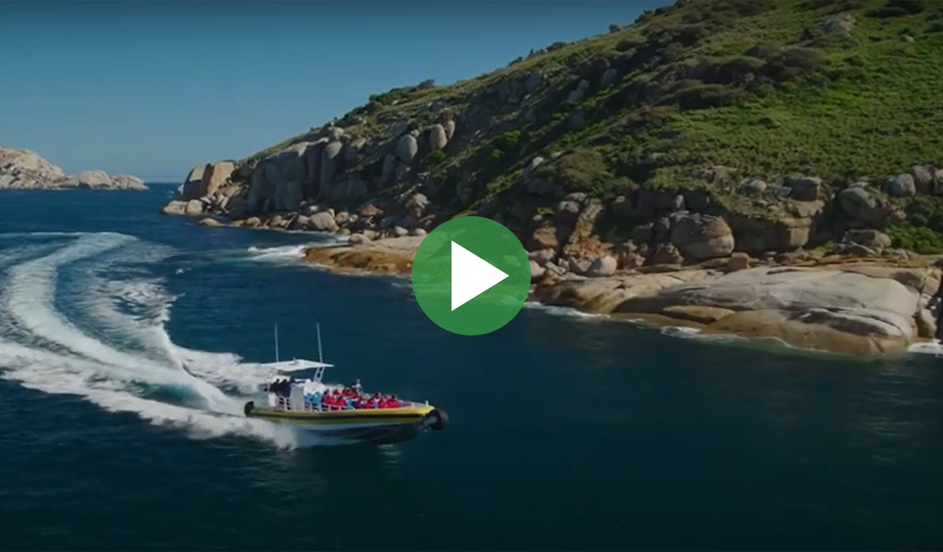 Still image from video of a boat on water with play icon overlay